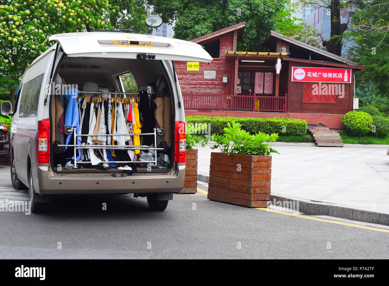 Clothes rack inside a van trunk during an outdoor street modeling session of the fashion industry in Guangzhou, China Stock Photo