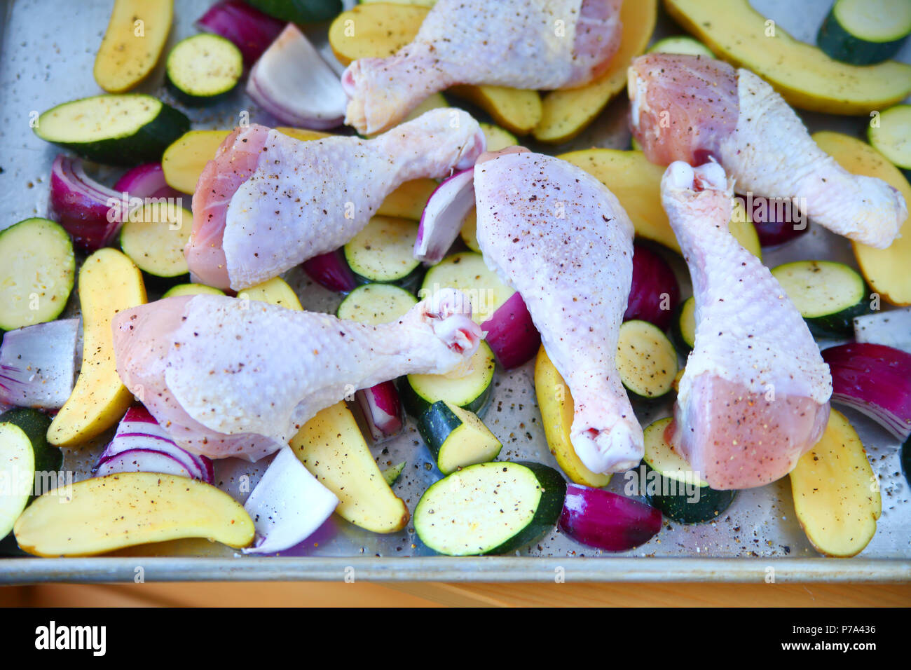Chicken sheet pan meal with zucchini, fingerling potatoes and onions Stock Photo