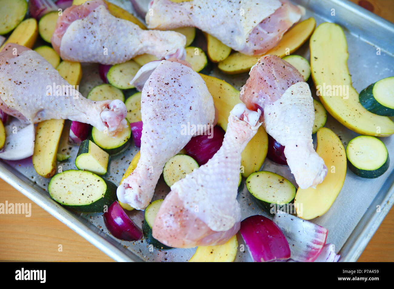 Overhead of chicken legs and vegetables before baking Stock Photo Alamy
