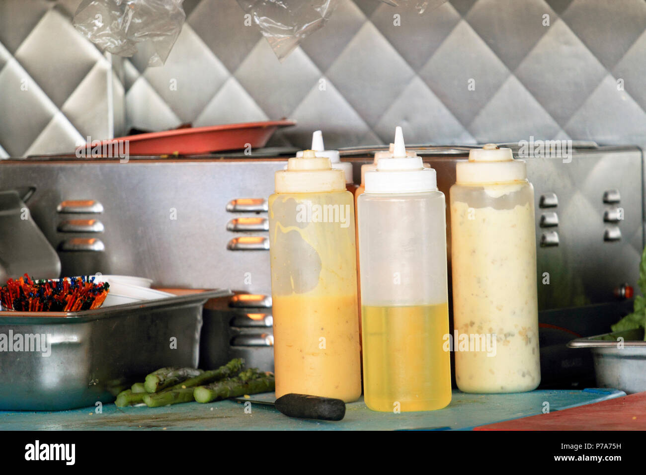 Plastic squeeze bottles at a restaurant work station Stock Photo