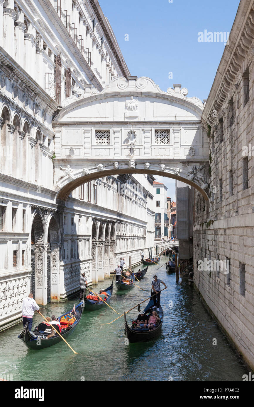 Gondolas with tourists rowing under the Bridge of Sighs (Ponte dei Sospiri) , San Marco, Venice, Veneto,  Italy between the Doges Palace and Venetian  Stock Photo