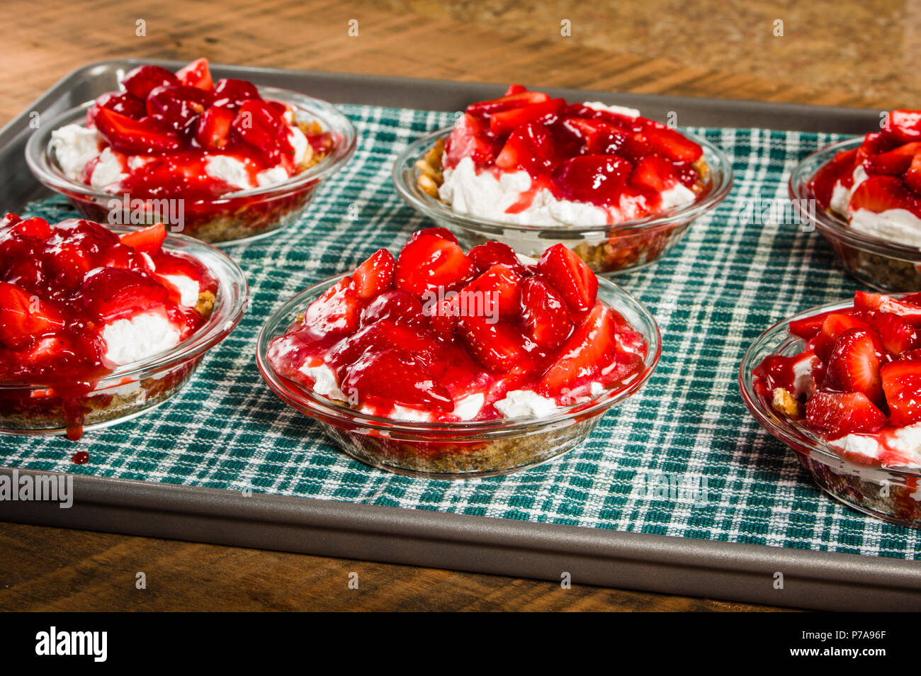 Strawberry pies with whipped cream on a baking sheet Stock Photo