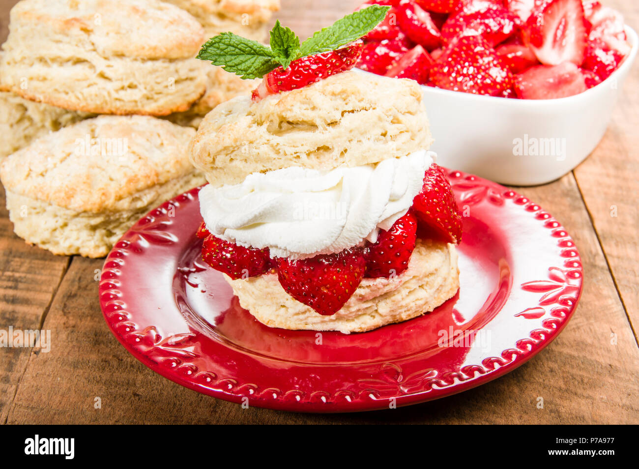 Strawberries and fresh whipped cream on baked biscuit Stock Photo