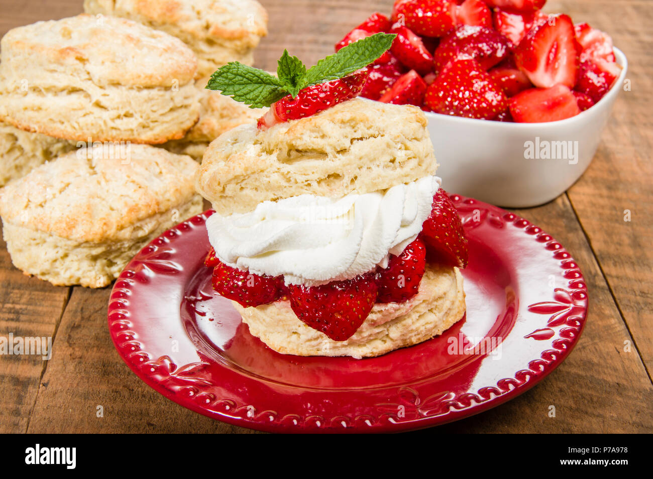 Strawberries and fresh whipped cream on baked biscuit Stock Photo