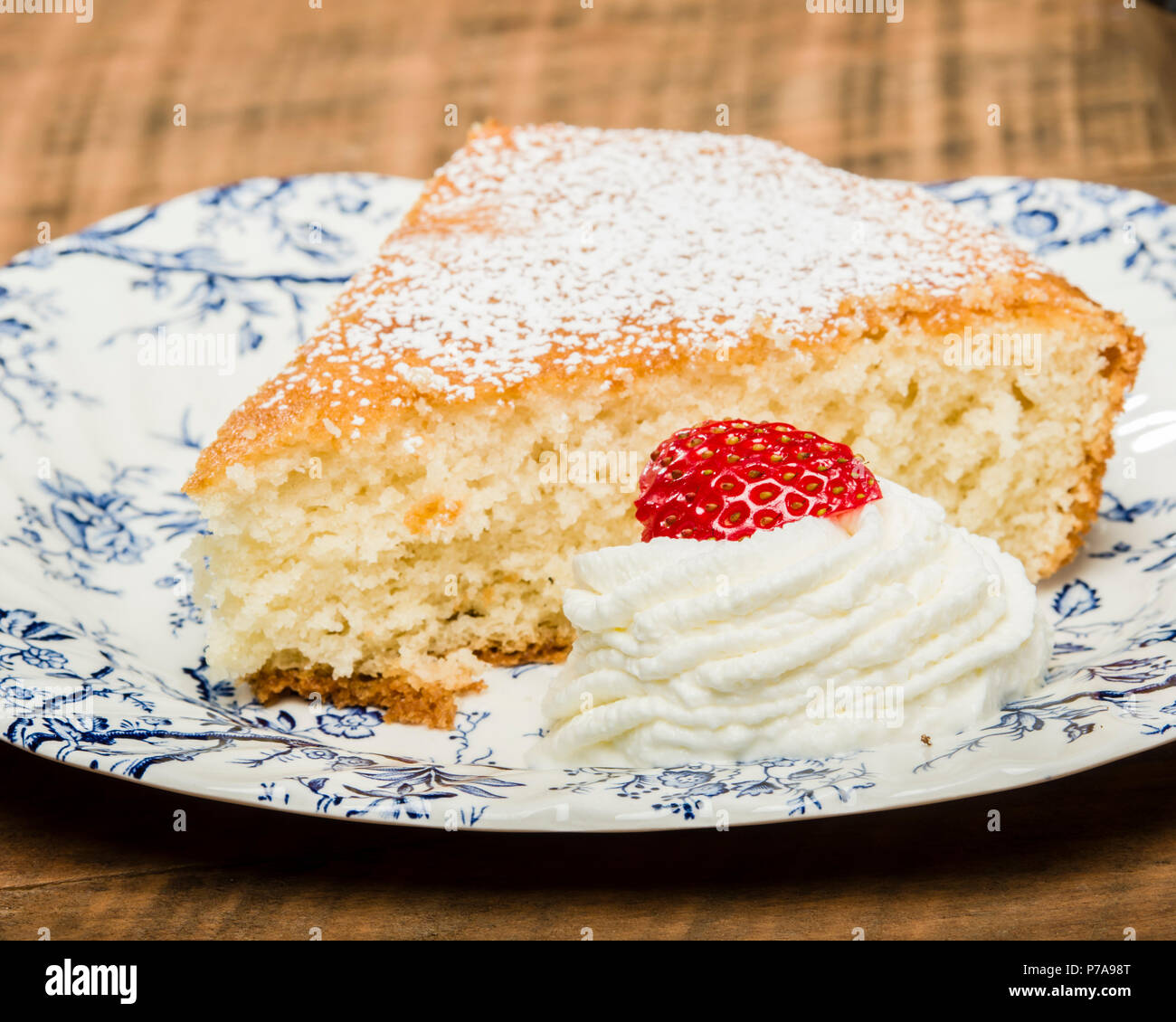 Yellow skillet cake with cream and strawberry Stock Photo