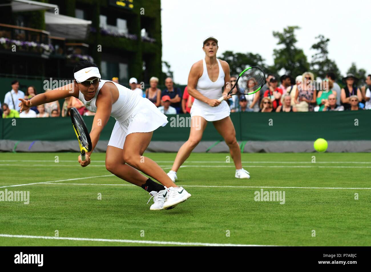 London, UK. 4th July, 2018. Xu Yifan (L) of China and Gabriela Dabrowski of Canada compete during the women's doubles first round match against Olga Savchuk of Ukraine and Alison Riske of the United States at the Wimbledon Championships 2018 in London, UK, on July 4, 2018. The match was suspended due to the rain. Credit: Guo Qiuda/Xinhua/Alamy Live News Stock Photo
