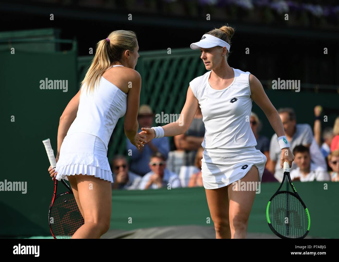 London, UK. 4th July, 2018. Olga Savchuk of Ukraine and Alison Riske (R) of the United States react during the women's doubles first round match against Xu Yifan of China and Gabriela Dabrowski of Canada at the Wimbledon Championships 2018 in London, UK, on July 4, 2018. The match was suspended due to the rain. Credit: Guo Qiuda/Xinhua/Alamy Live News Stock Photo