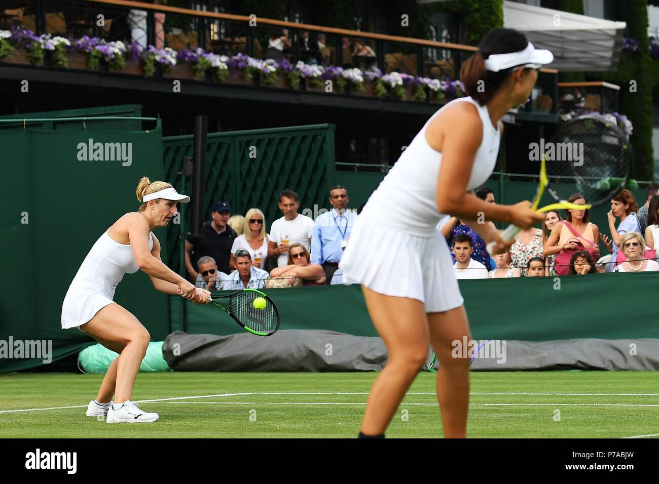 London, UK. 4th July, 2018. Xu Yifan (R) of China and Gabriela Dabrowski of Canada compete during the women's doubles first round match against Olga Savchuk of Ukraine and Alison Riske of the United States at the Wimbledon Championships 2018 in London, UK, on July 4, 2018. The match was suspended due to the rain. Credit: Guo Qiuda/Xinhua/Alamy Live News Stock Photo