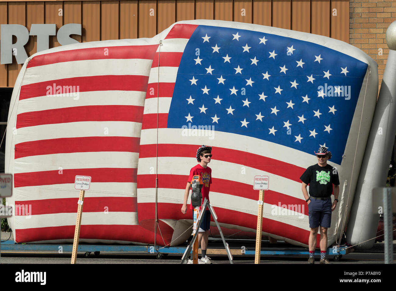 Anchorage, Alaska. 4th July, 2018. A giant inflatable flag is marched down the street during the annual Independence Day parade July 4, 2018 in Anchorage, Alaska. Credit: Planetpix/Alamy Live News Stock Photo