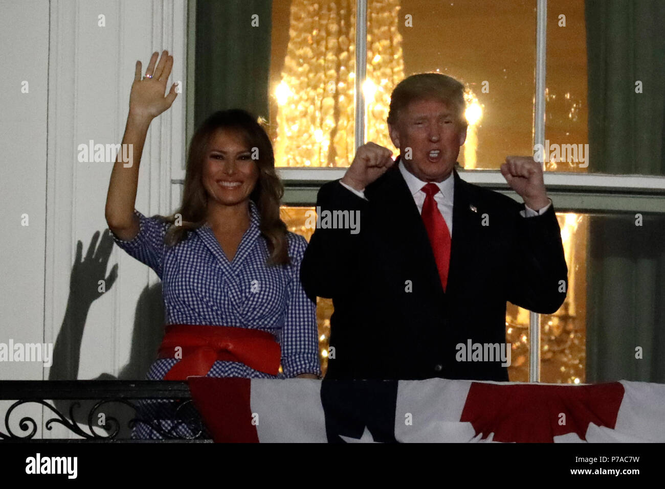 Washington, DC, USA. 4th July, 2018. United States President Donald J. Trump  and First Lady Melania Trump react from the Truman Balcony of the White  House during a fireworks display in Washington,