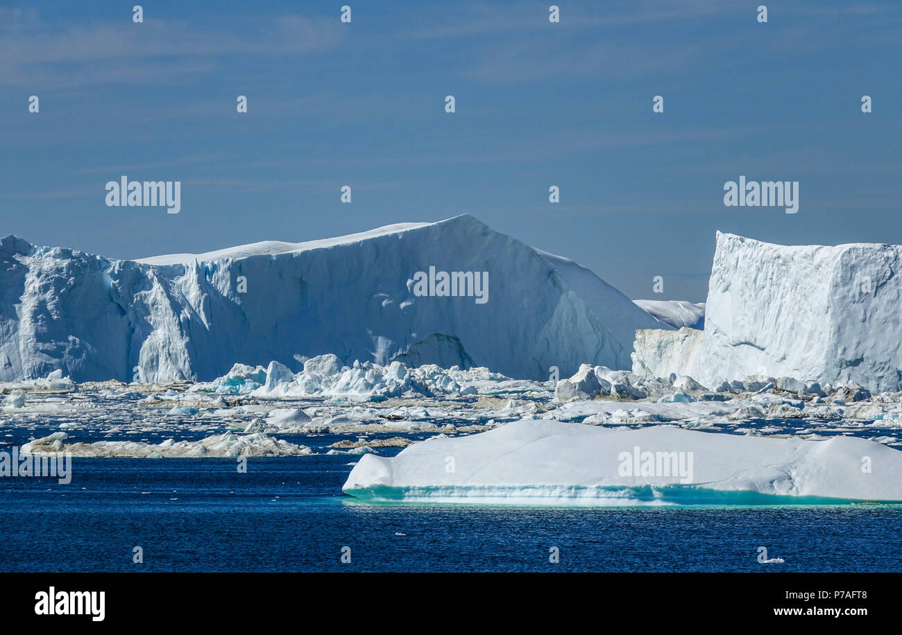 20.06.2018, Gronland, Denmark: A huge iceberg drifts in the sea off the coastal town of Ilulissat in western Greenland. The city is located on the Ilulissat Icefjord, which is known for its particularly large icebergs in Disko Bay. Photo: Patrick Pleul / dpa-Zentralbild / ZB | usage worldwide Stock Photo