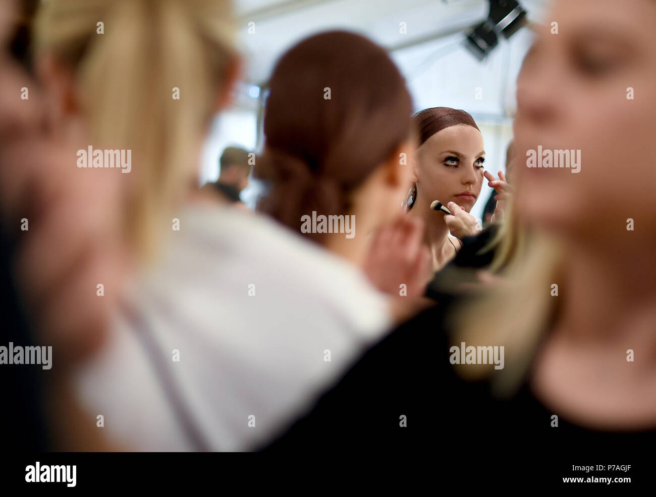 5 July 2018, Berlin, Germany: Models are prepared backstage for the ...