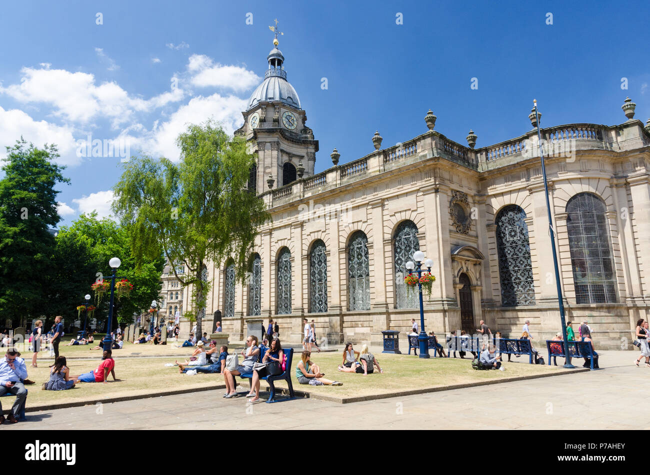 Birmingham, UK. 5th July 2018. Office workers enjoy the lunchtime sunshine in the grounds of St Philip's Cathedral in the centre of Birmingham. Credit: Nick Maslen/Alamy Live News Stock Photo