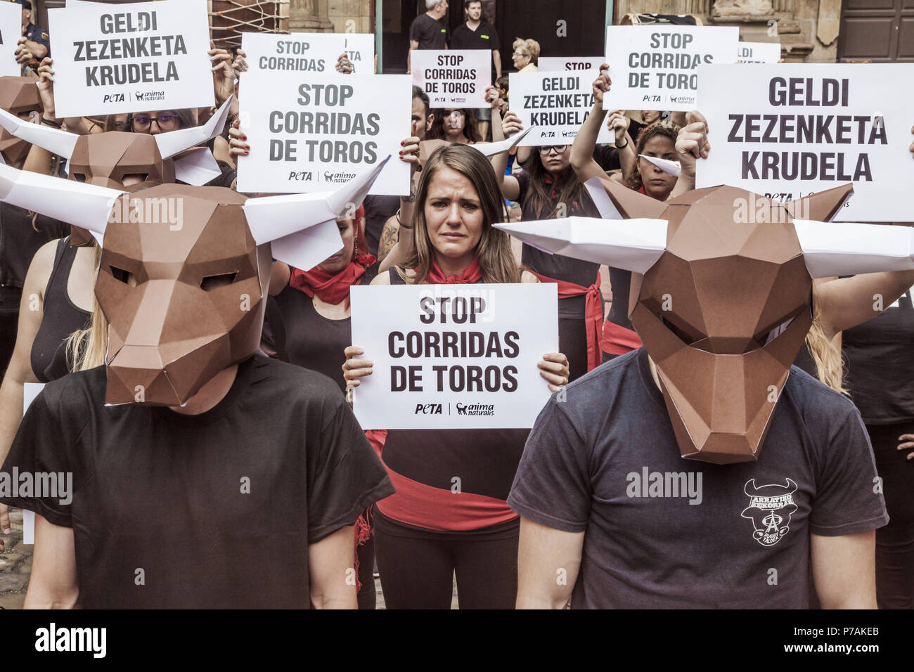Pamplona, Navarra, Spain. 5th July, 2018. Protest against animal cruelty in bull fightings before San Fermin celebrations in Pamplona, Spain. Banner says ''stop bullfightings'' and some activists wear a paperboard bullhead mask. Credit: Celestino Arce/ZUMA Wire/Alamy Live News Stock Photo