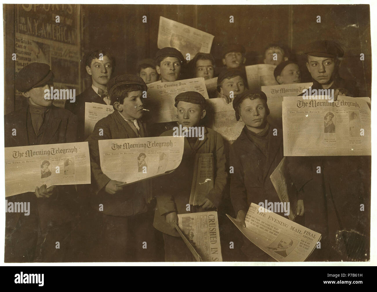 2 A.M. February 12,1908. Papers just out. Boys starting out on morning round. Ages 13 years and upward. At the side door of Journal Building near Brooklyn Bridge. LOC cph.3b01716. Stock Photo