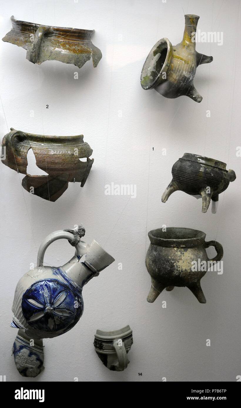 Polish pottery. Fragments of kitchen utensils of three-legged pots and pans and flat bottom pots. 17th-18th century. Archaeological Museum of Gdansk. Poland. Europe. Stock Photo