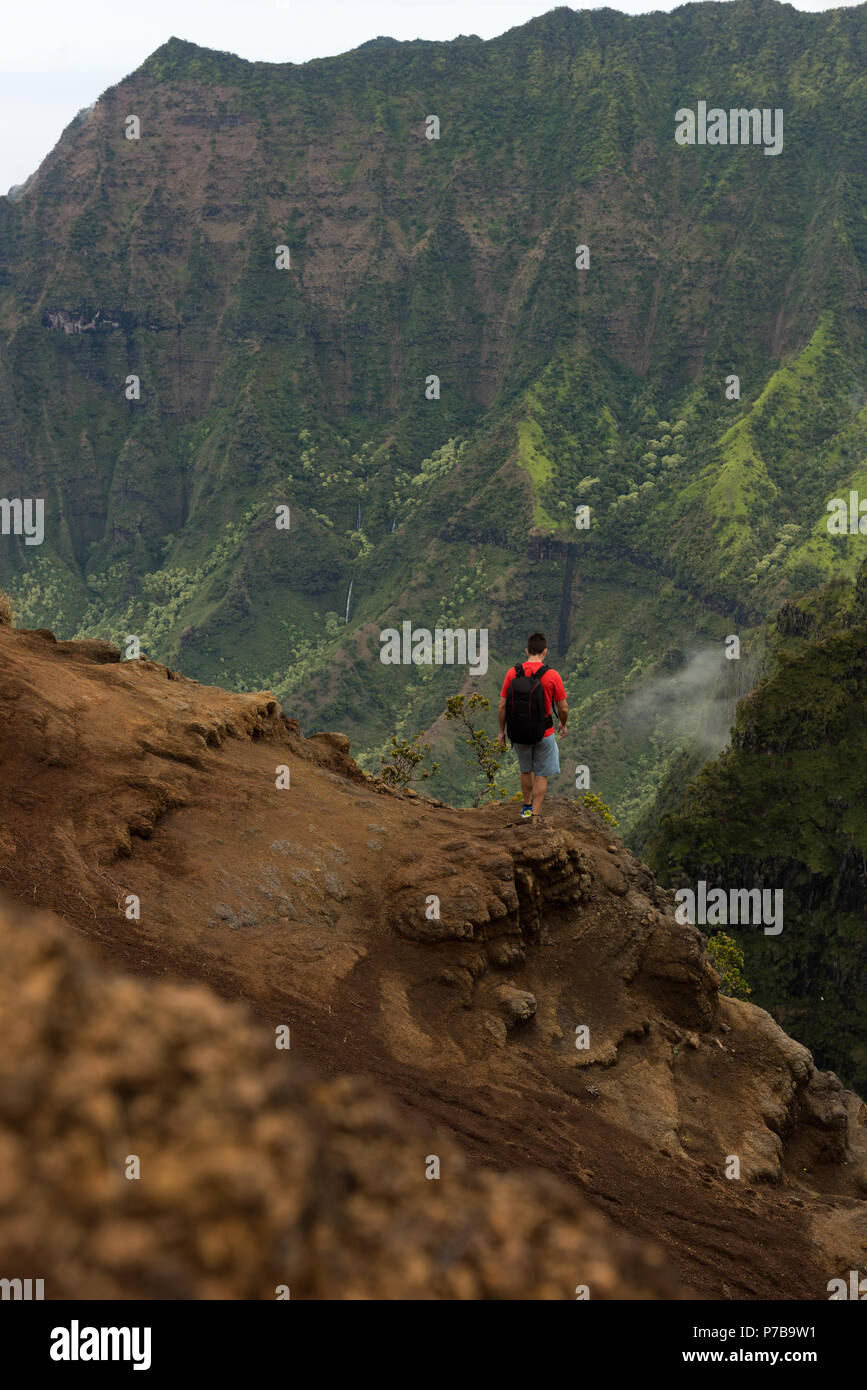 Hiker standing at the edge of mountain Stock Photo