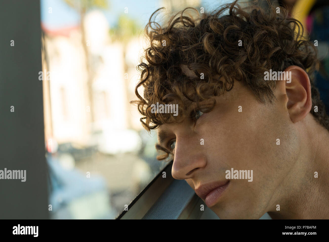 Thoughtful young man travelling in the bus Stock Photo