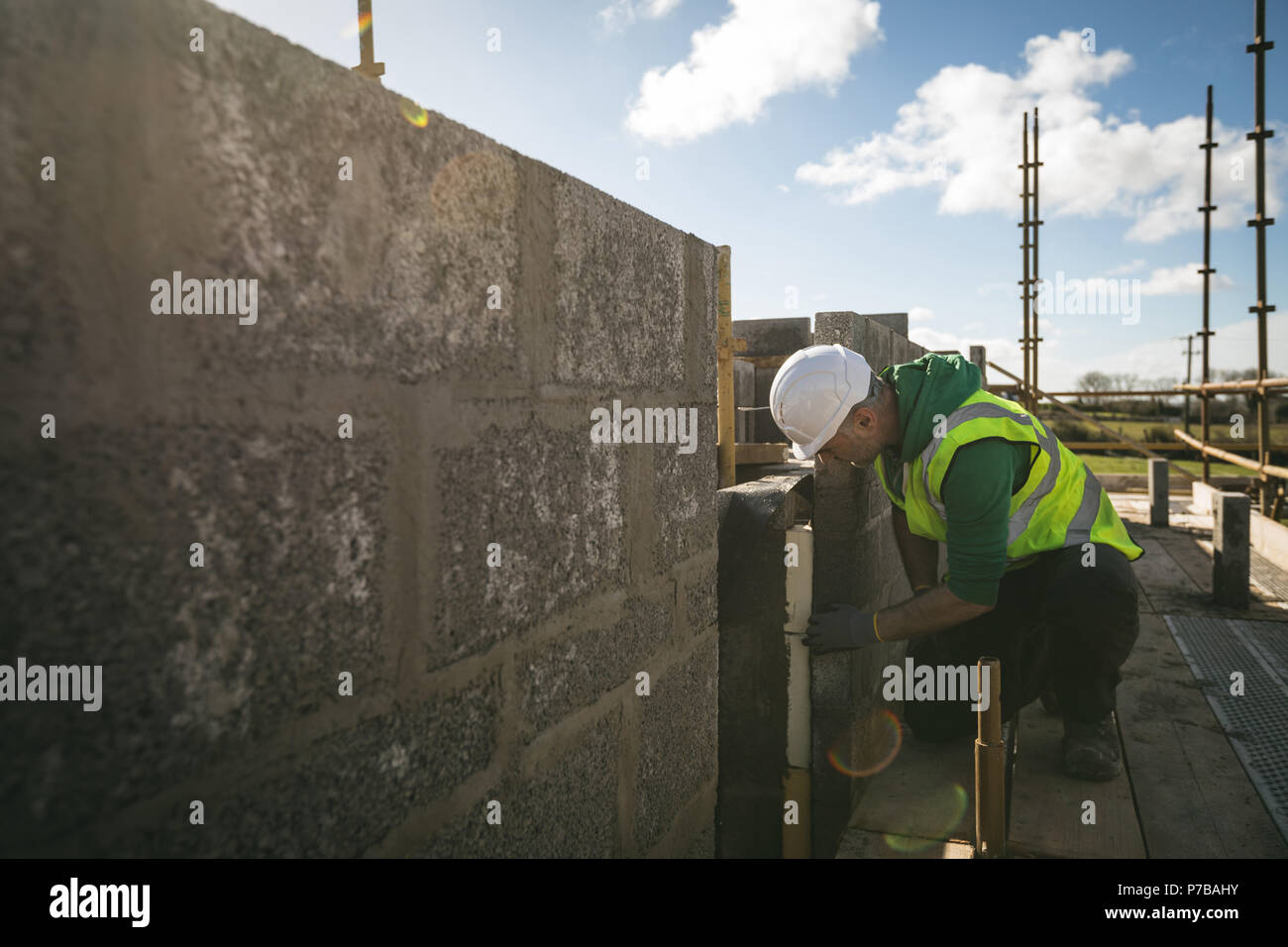 Engineer examining the wall at construction site Stock Photo
