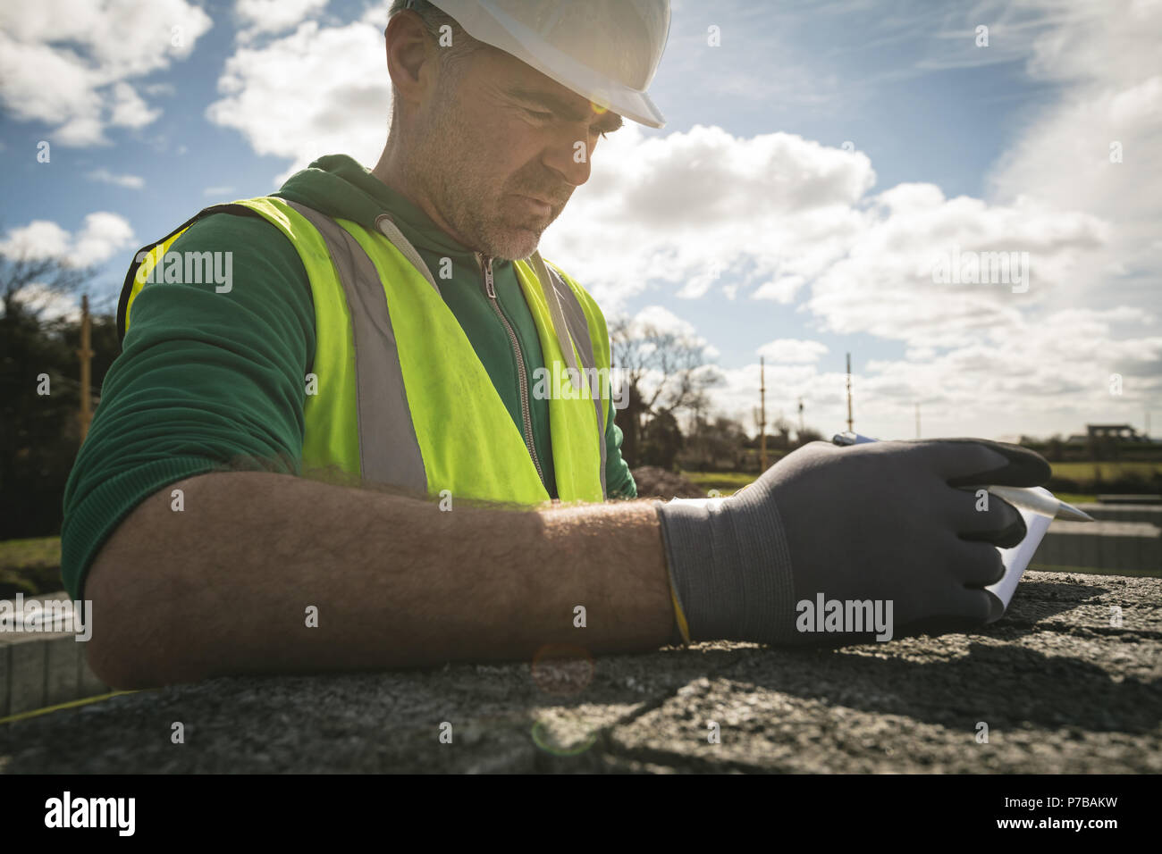 Engineer reading his notes at the construction site Stock Photo