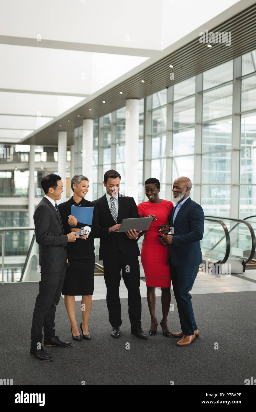 Group of happy businesspeople interacting with eachother Stock Photo