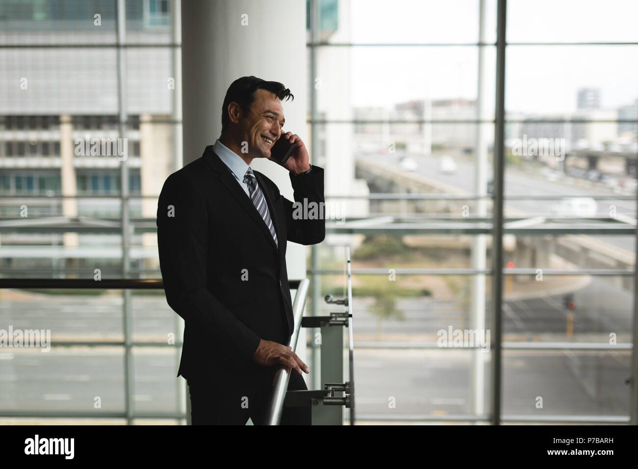 Businessman talking on the mobile phone in office Stock Photo