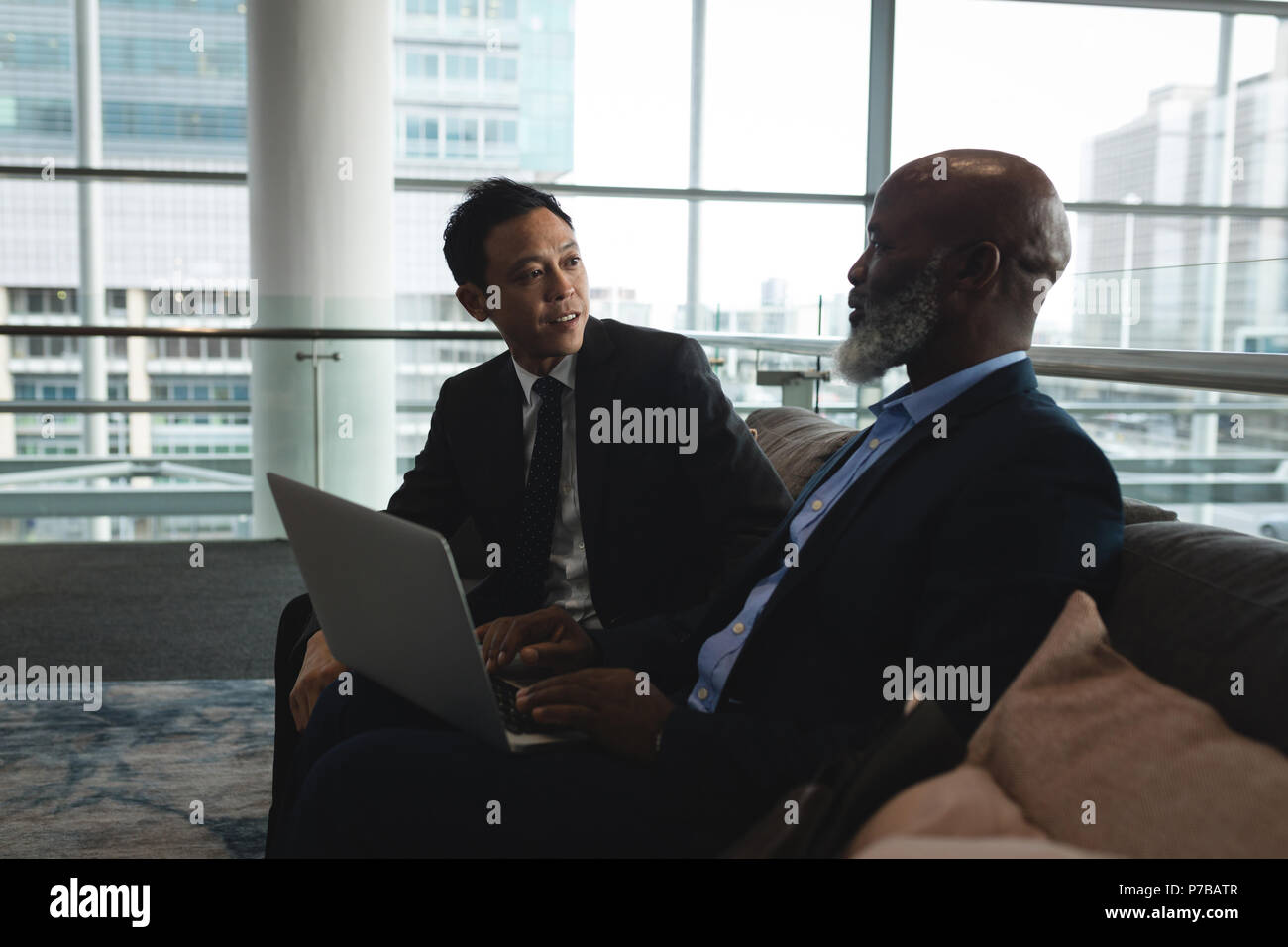 Businessmen with laptop discussing with the office Stock Photo