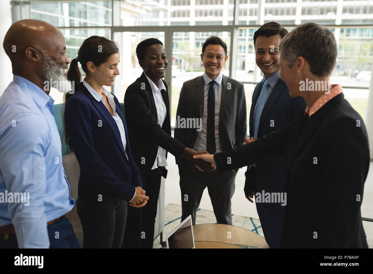 Businesspeople shaking hands in the office Stock Photo