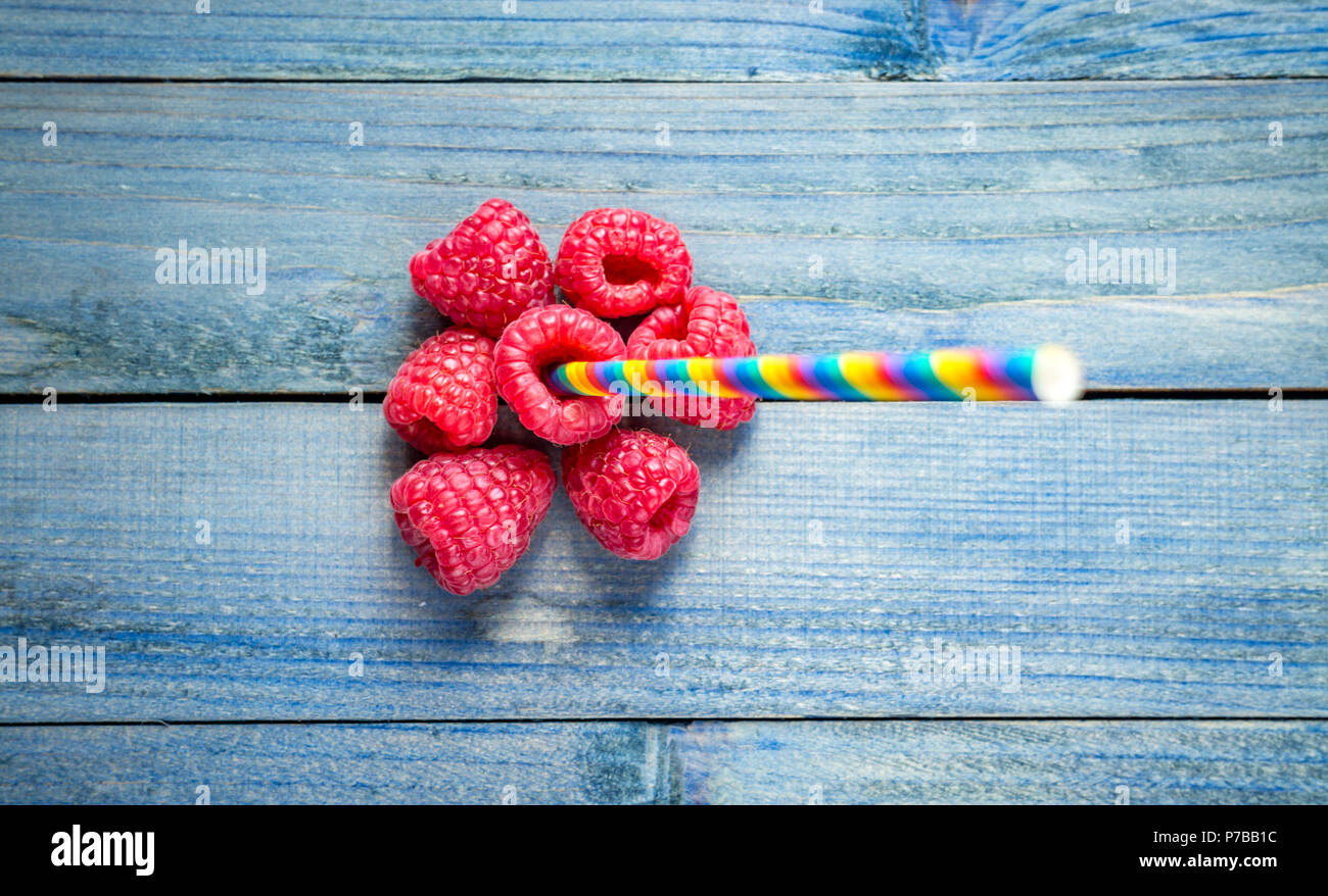 Creative layout made of raspberry. Flat lay, Colorful straw sticking ...