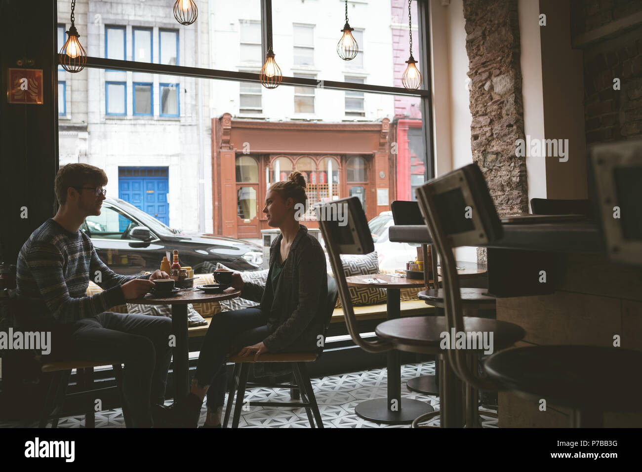 Couple interacting with each other while having coffee Stock Photo