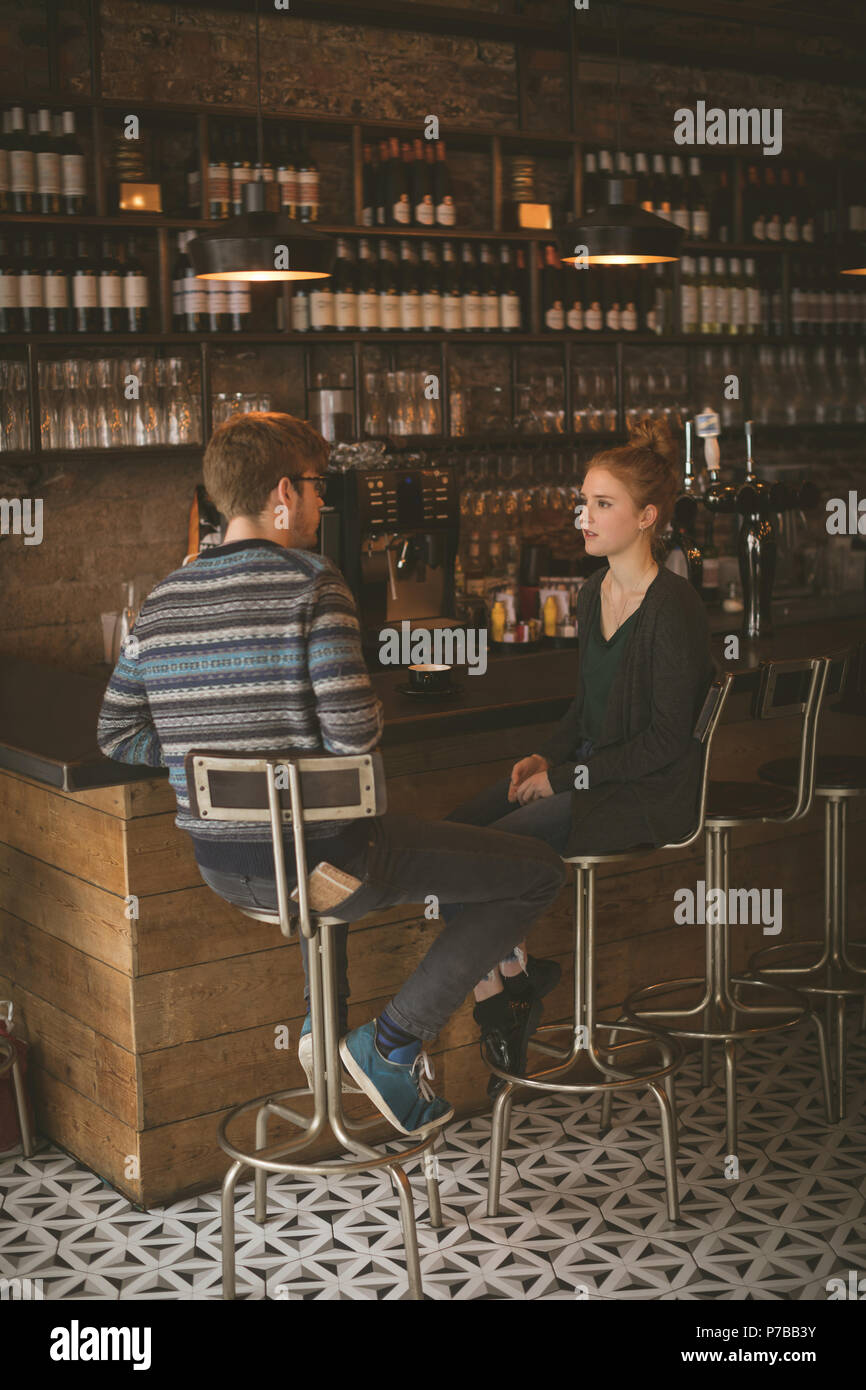 Couple sitting at the bar counter Stock Photo Alamy