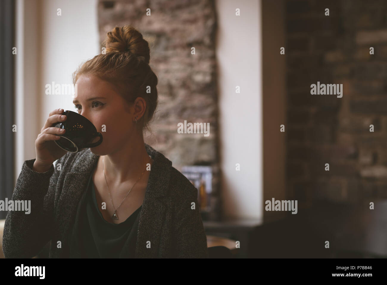 Woman having coffee at cafe Stock Photo