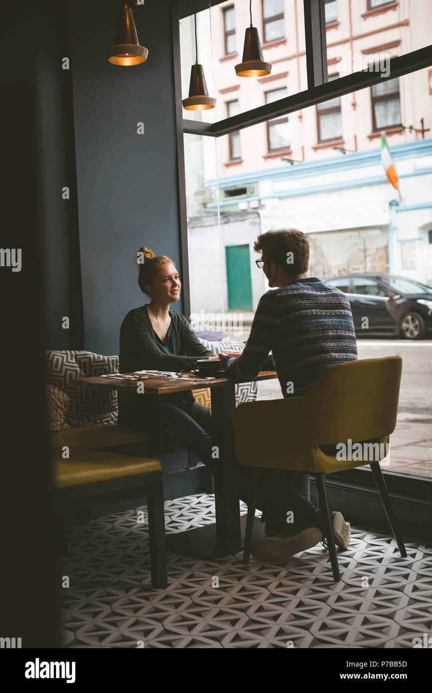 Couple talking to each other in the cafe Stock Photo