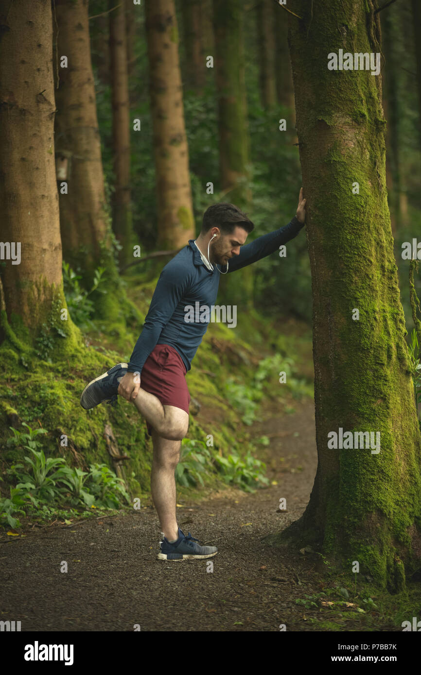 Fit man doing stretching exercise Stock Photo