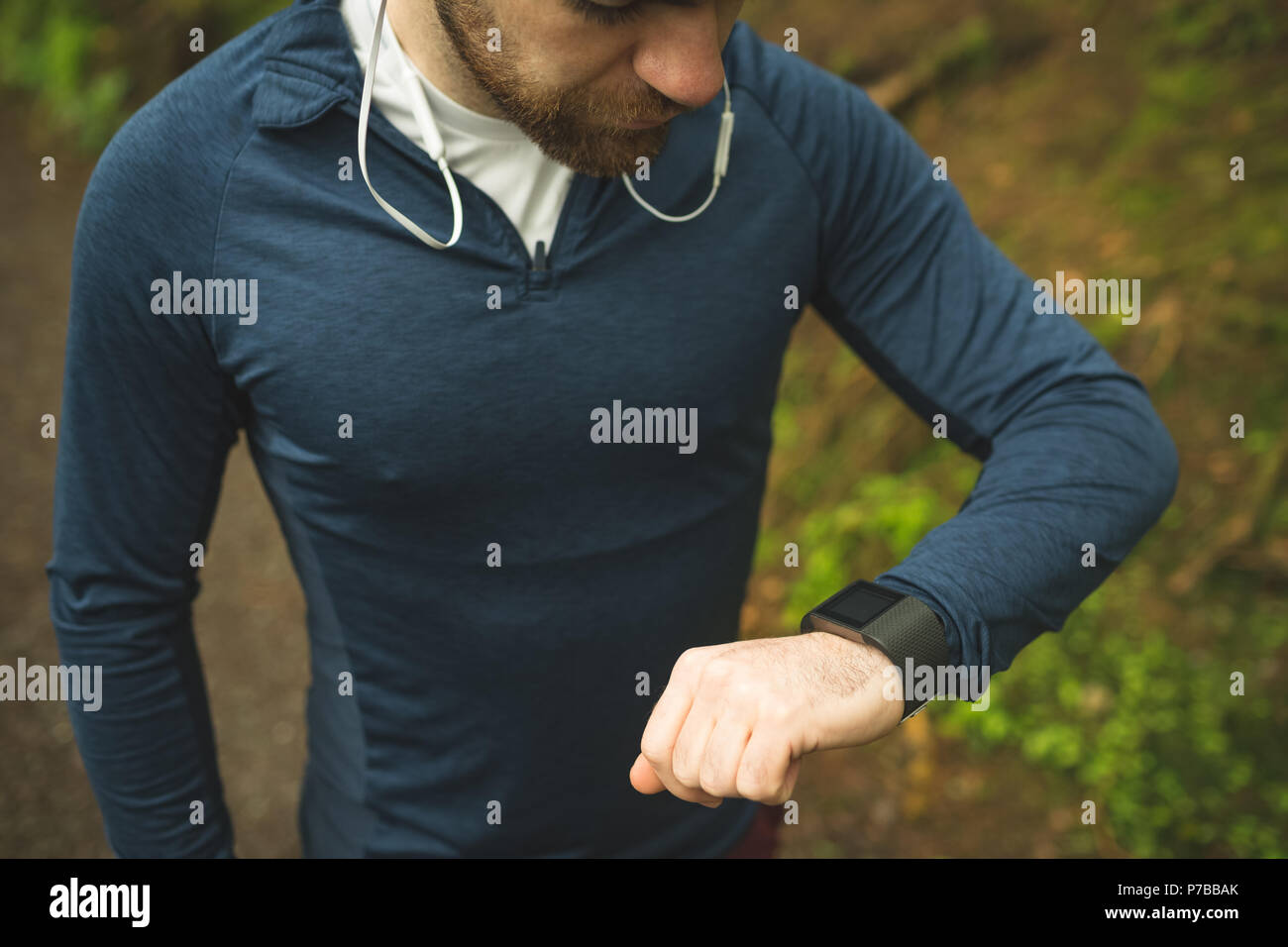 Handsome man checking time on smartwatch Stock Photo