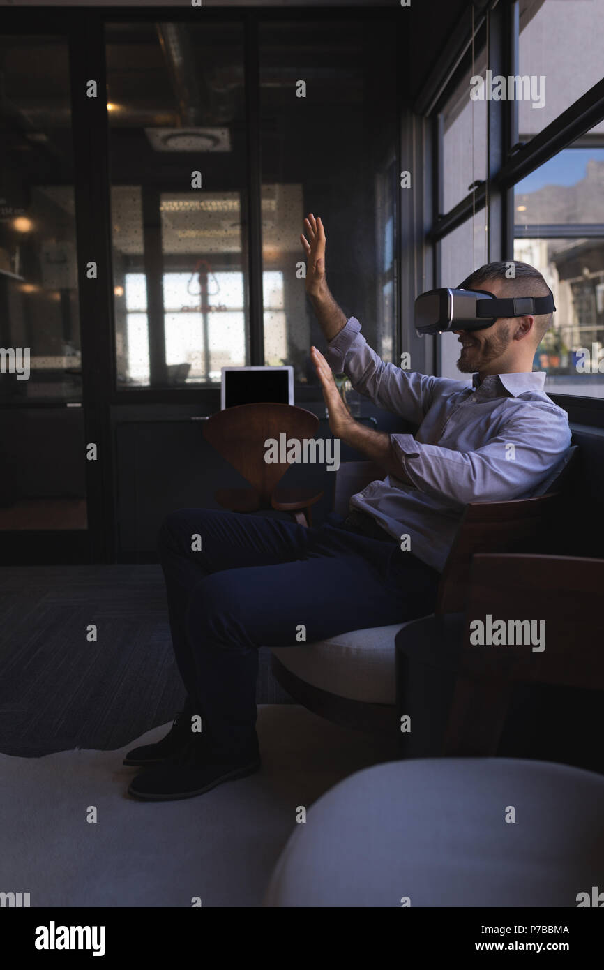 Businessman using virtual reality headset Stock Photo