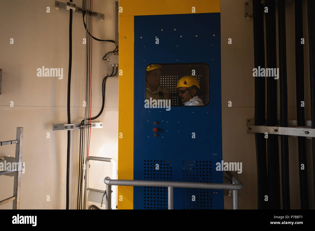 Engineer standing inside service lift Stock Photo