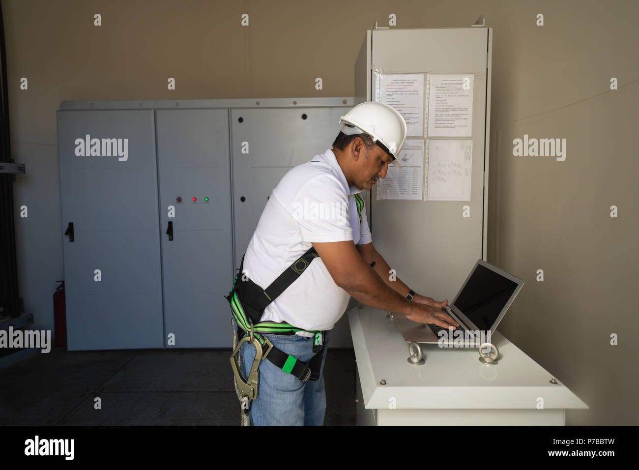 Engineer using a laptop inside the wind mill Stock Photo