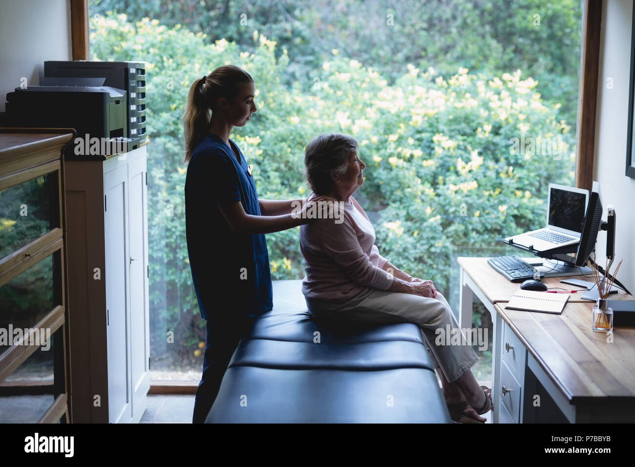 Physiotherapist giving a massage to senior woman Stock Photo