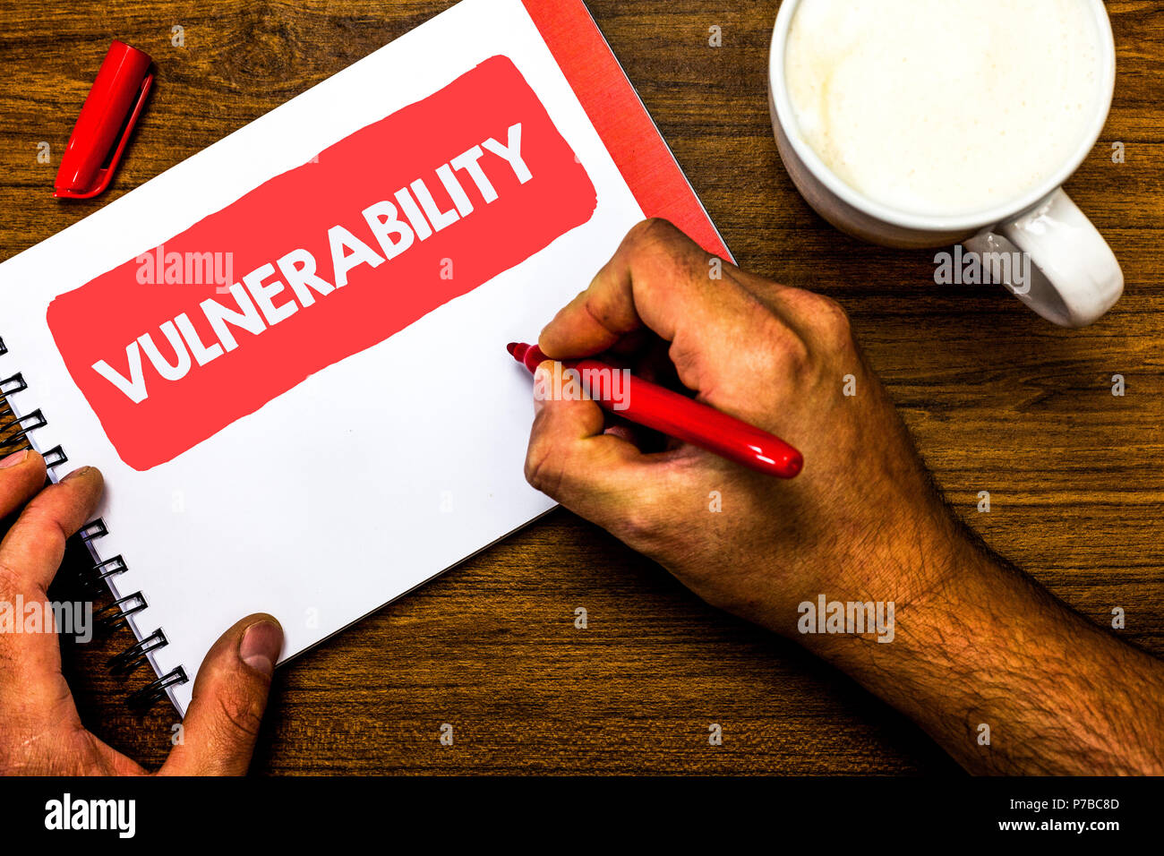 Text sign showing Vulnerability. Conceptual photo Information susceptibility systems bug exploitation attacker Cup marker red pen notepad white paper  Stock Photo