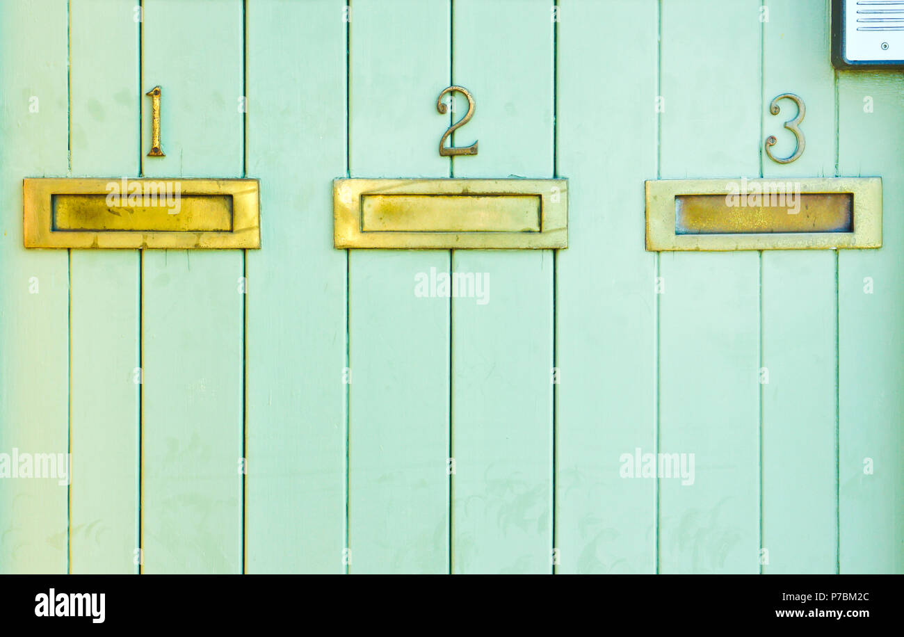 Three letterboxes mounted in a wooden panel Stock Photo