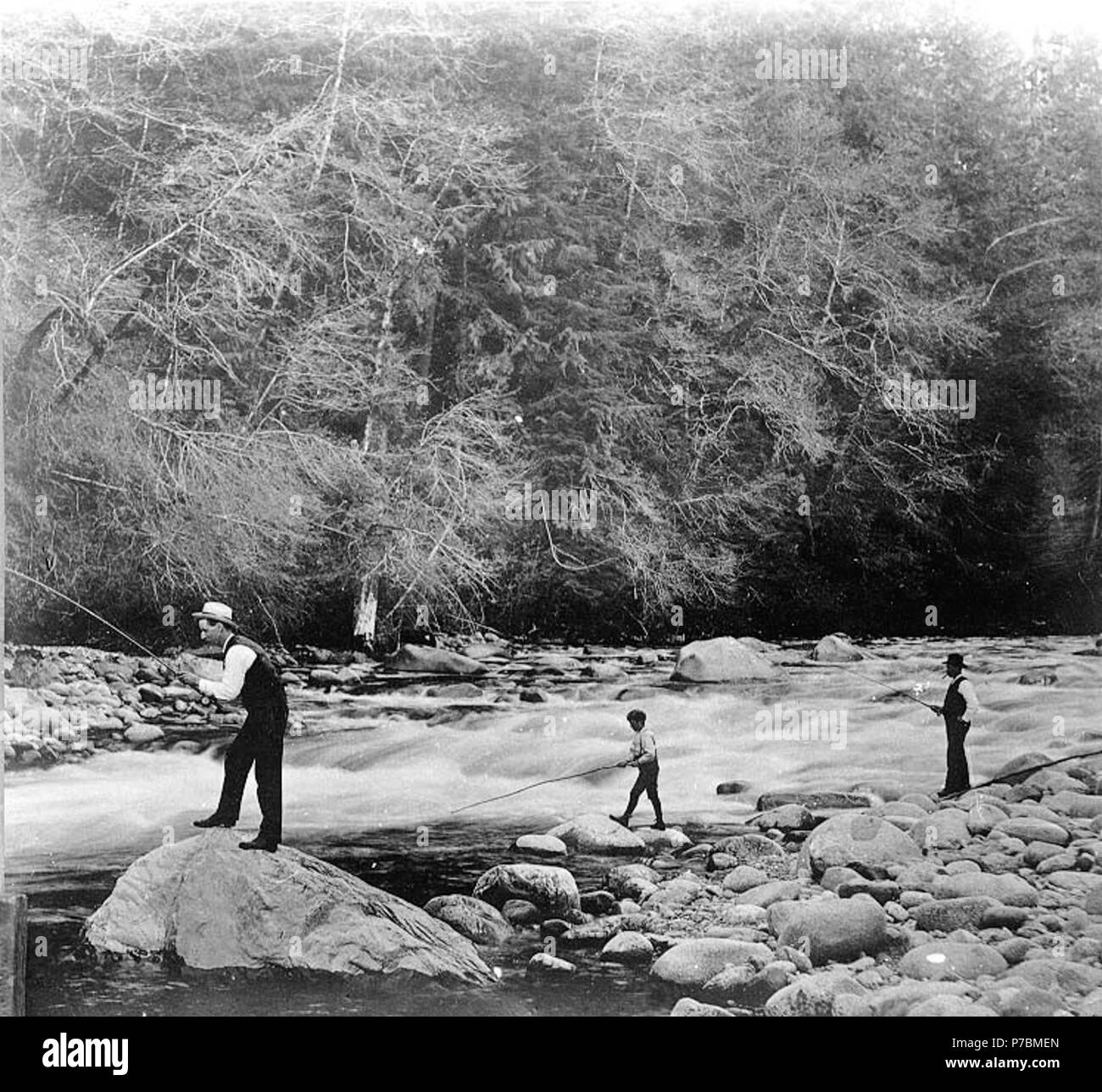 English: Two men and boy fishing in unidentified river with poles