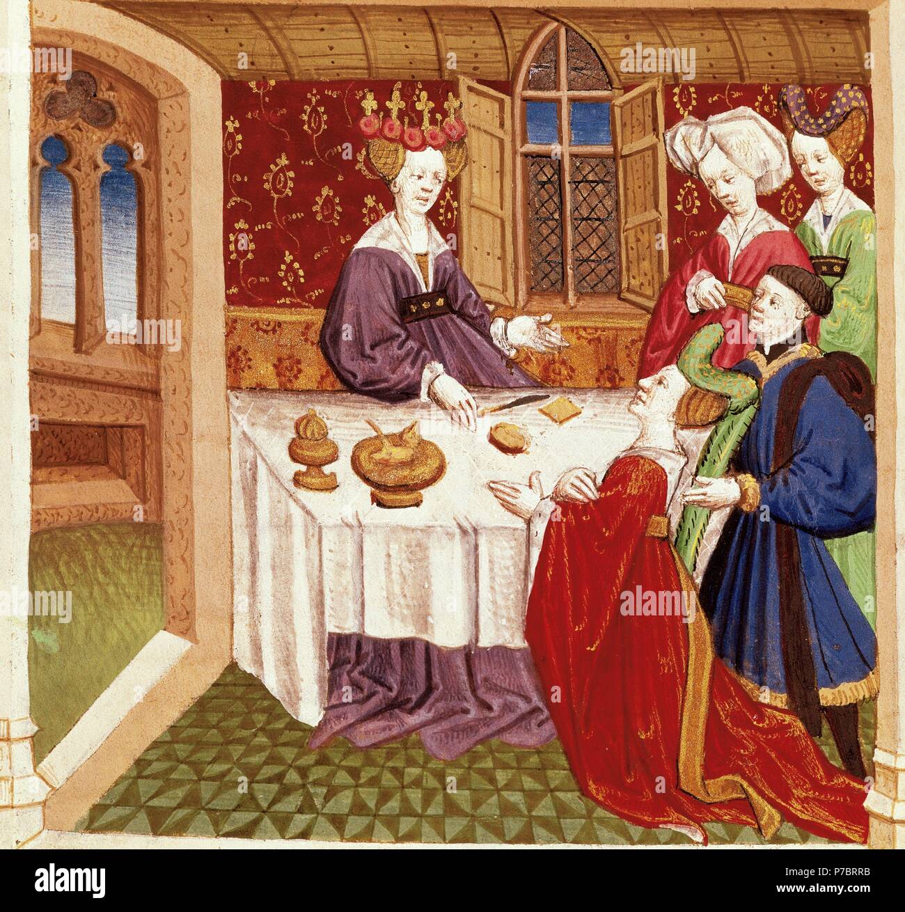 Tristan and Iseult. French medieval poetry, inspired by Celtic legend. Princess Iseult kneeling imploring the protection of Queen Guinevere, sitting at the table. Miniature of French School. Manuscript on prose, 15th century. Conde Museum. Chantilly Castle. France. Stock Photo
