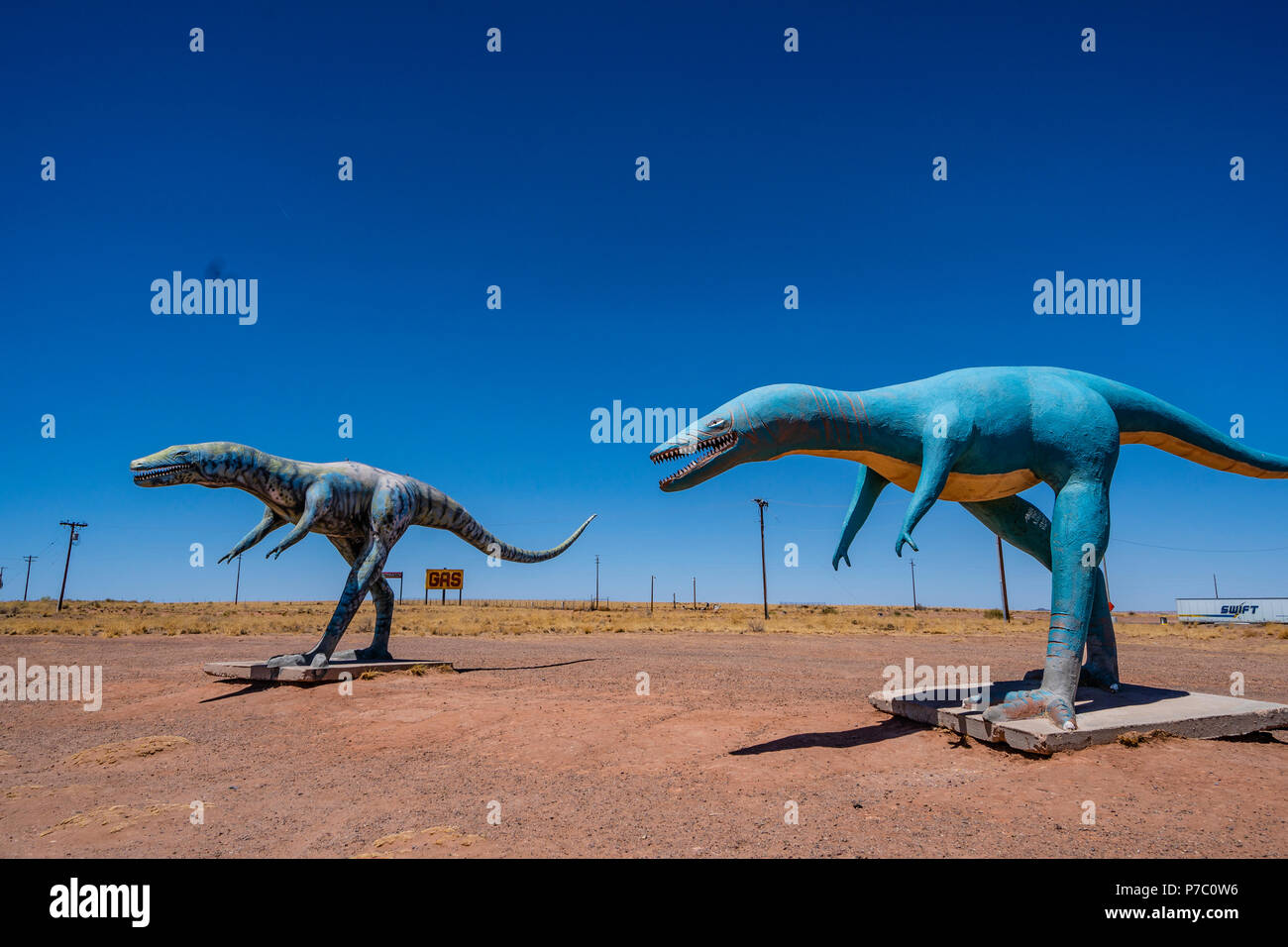 Two lifesize dinosaurs are a roadside attraction on Interstate 40