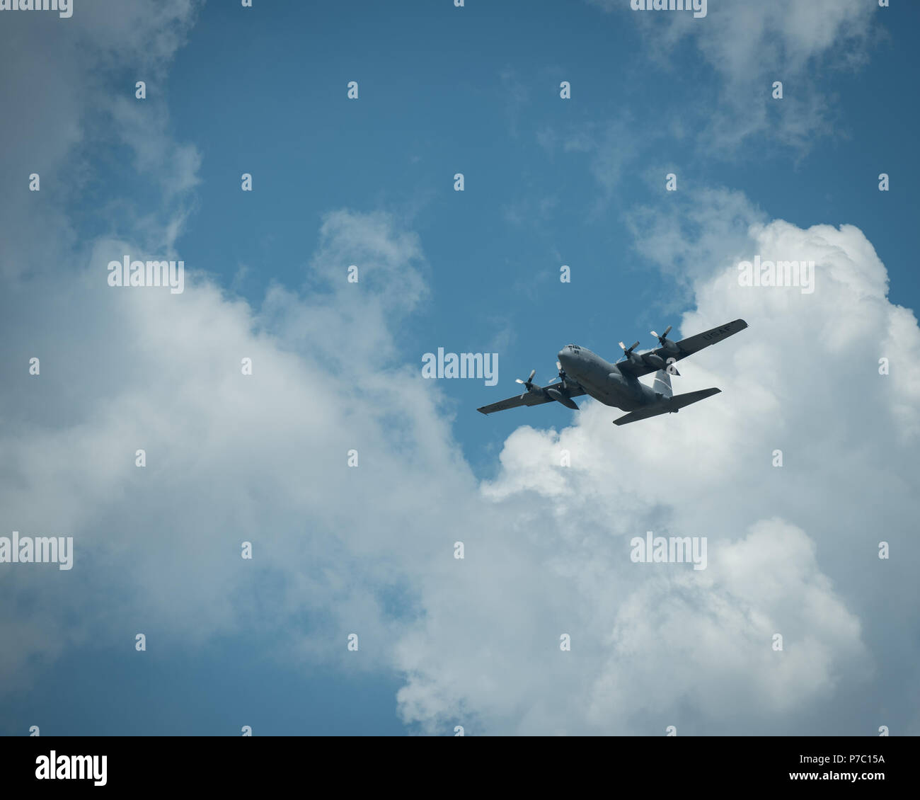 A C-130 Hercules aircraft flies over the Kentucky Air National Guard Base in Louisville, Ky., July 4, 2018, carrying Air National Guardsmen from the 123rd Airlift Wing who were returning from a deployment to the Persian Gulf. The Airmen have been flying troops and cargo across the U.S. Central Command Area of Responsibility since March in support of Operation Inherent Resolve. (U.S. Air National Guard photo by Lt. Col. Dale Greer) Stock Photo