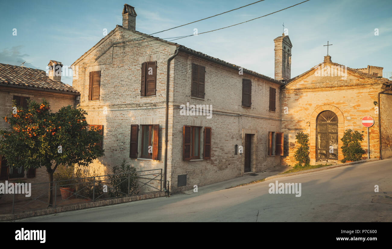 Street view of Fermo town with old living houses at evening, Italy. Vintage toned photo Stock Photo