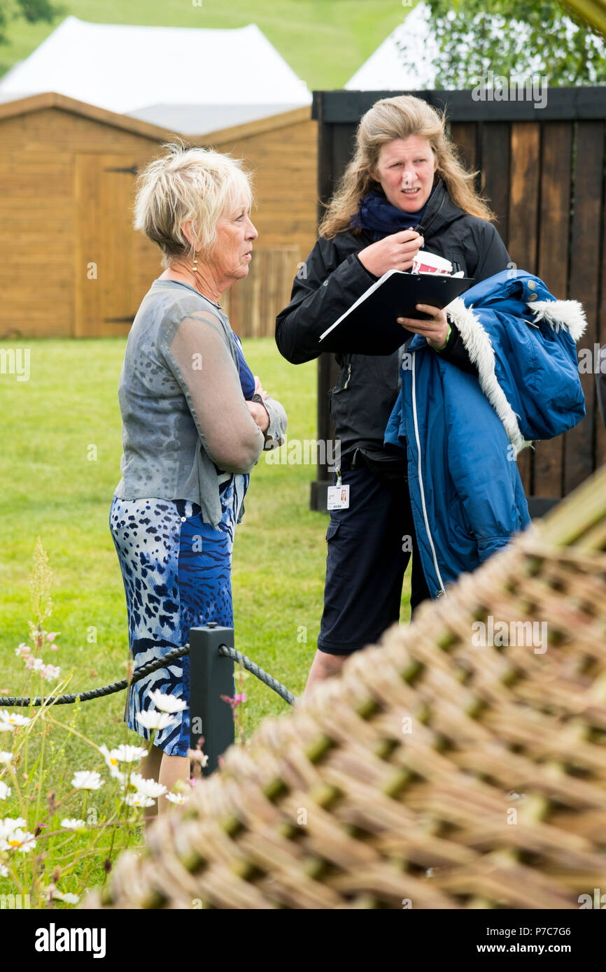 Carol Klein, gardening expert, standing with female tv crew member at RHS Chatsworth Flower Show, Chatsworth House, Derbyshire, England, UK. Stock Photo