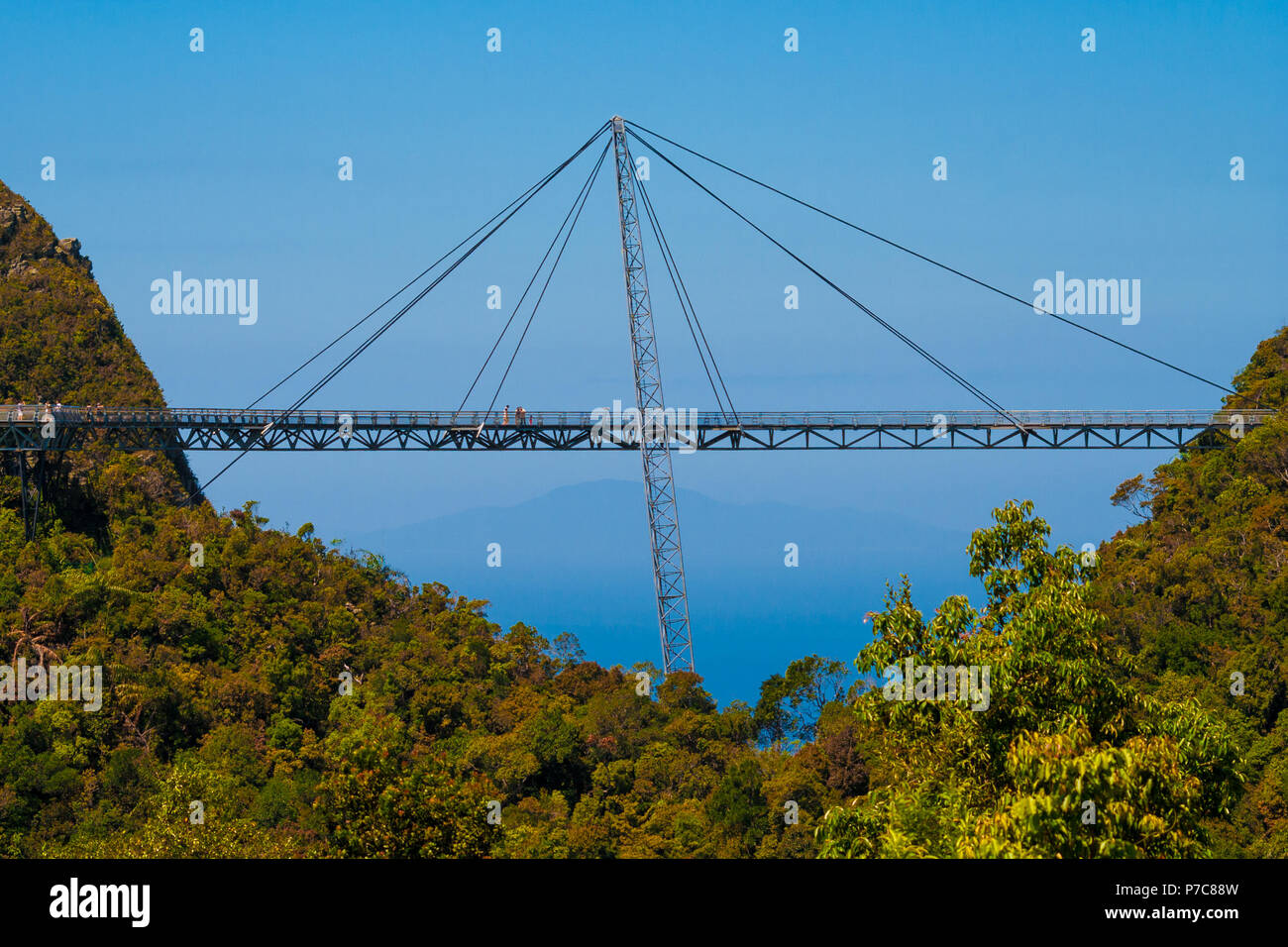 Side view of the amazing Langkawi Sky Bridge, a curved pedestrian cable-stayed bridge, suspended by cables from a single pylon, connecting two hilltop Stock Photo