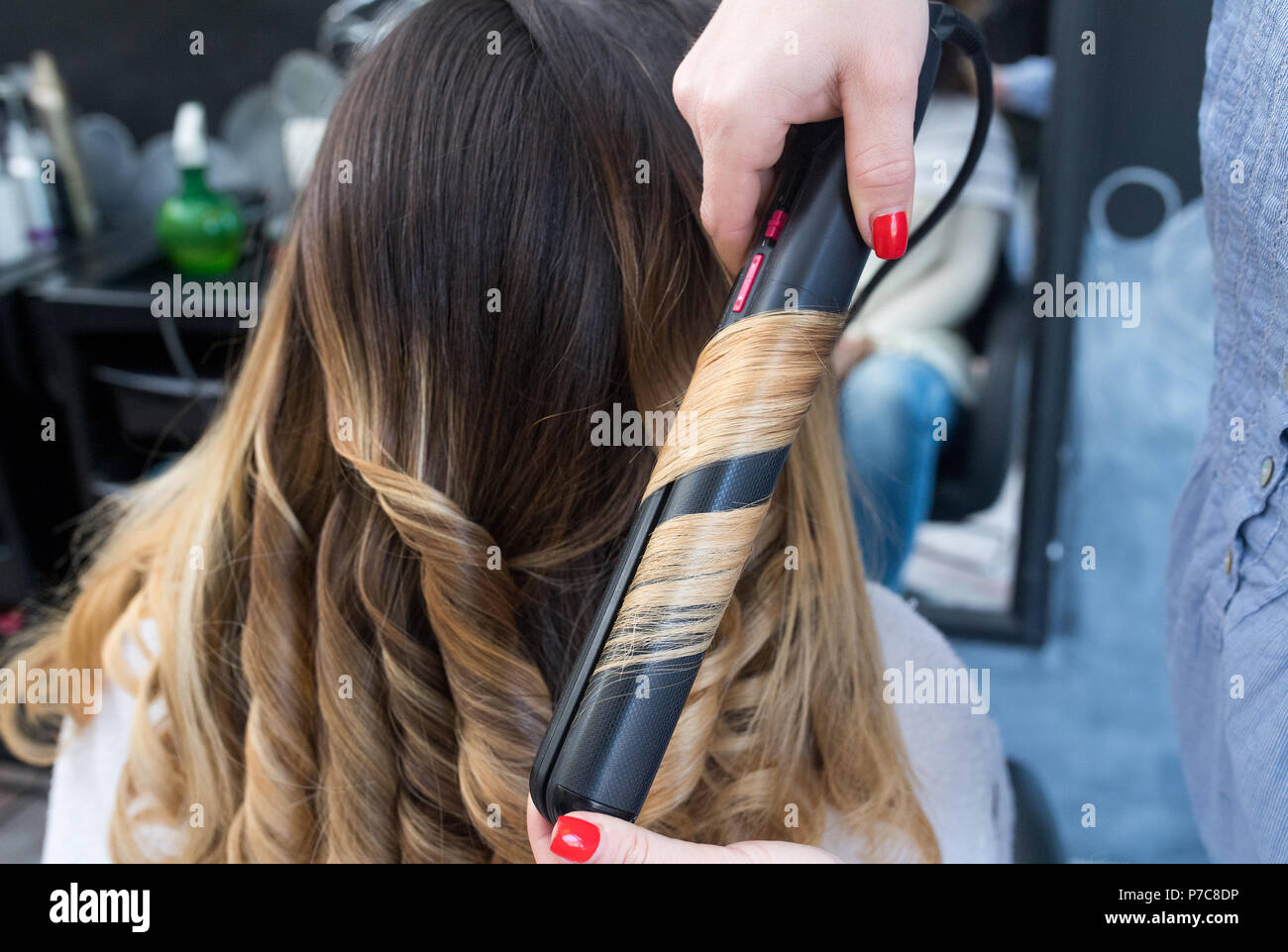 Professional Hairdresser Curling Ombre Hair With Iron In Beauty