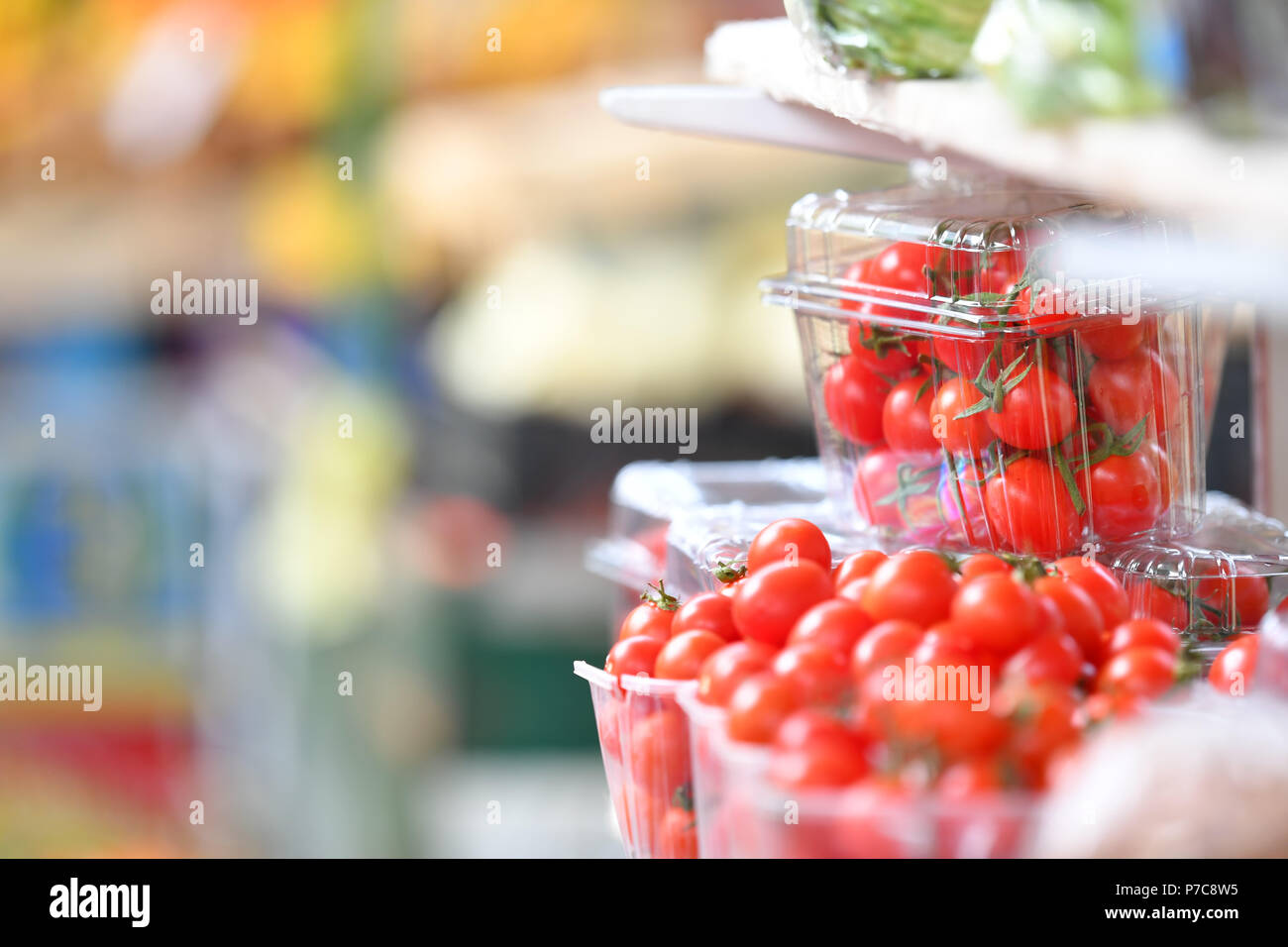 Fresh cherry tomatoes in plastic box at market place Stock Photo - Alamy